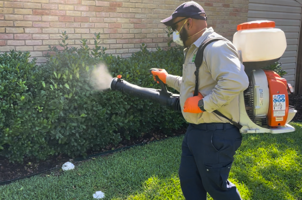 Village Green technician Orlando applying a mosquito treatment.
